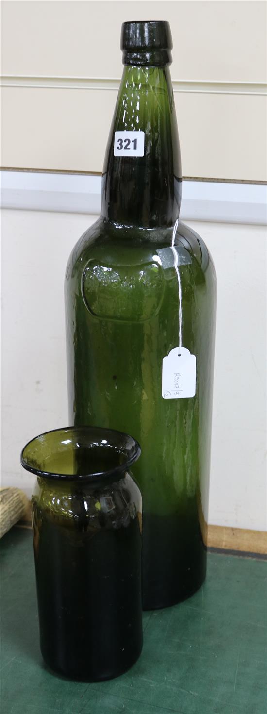 A large empty Sandemans port bottle and a dark olive green glass jar, 18th/19th century